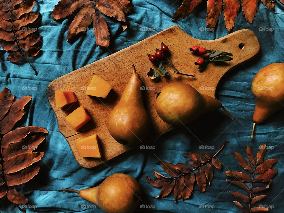 Fresh ripe pears on rustic wooden board 