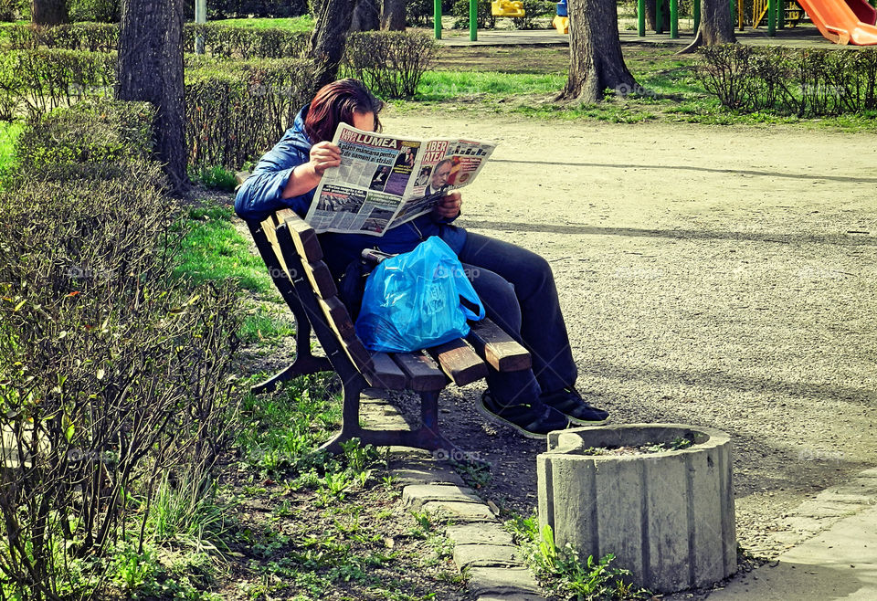 reading newspapers in the park