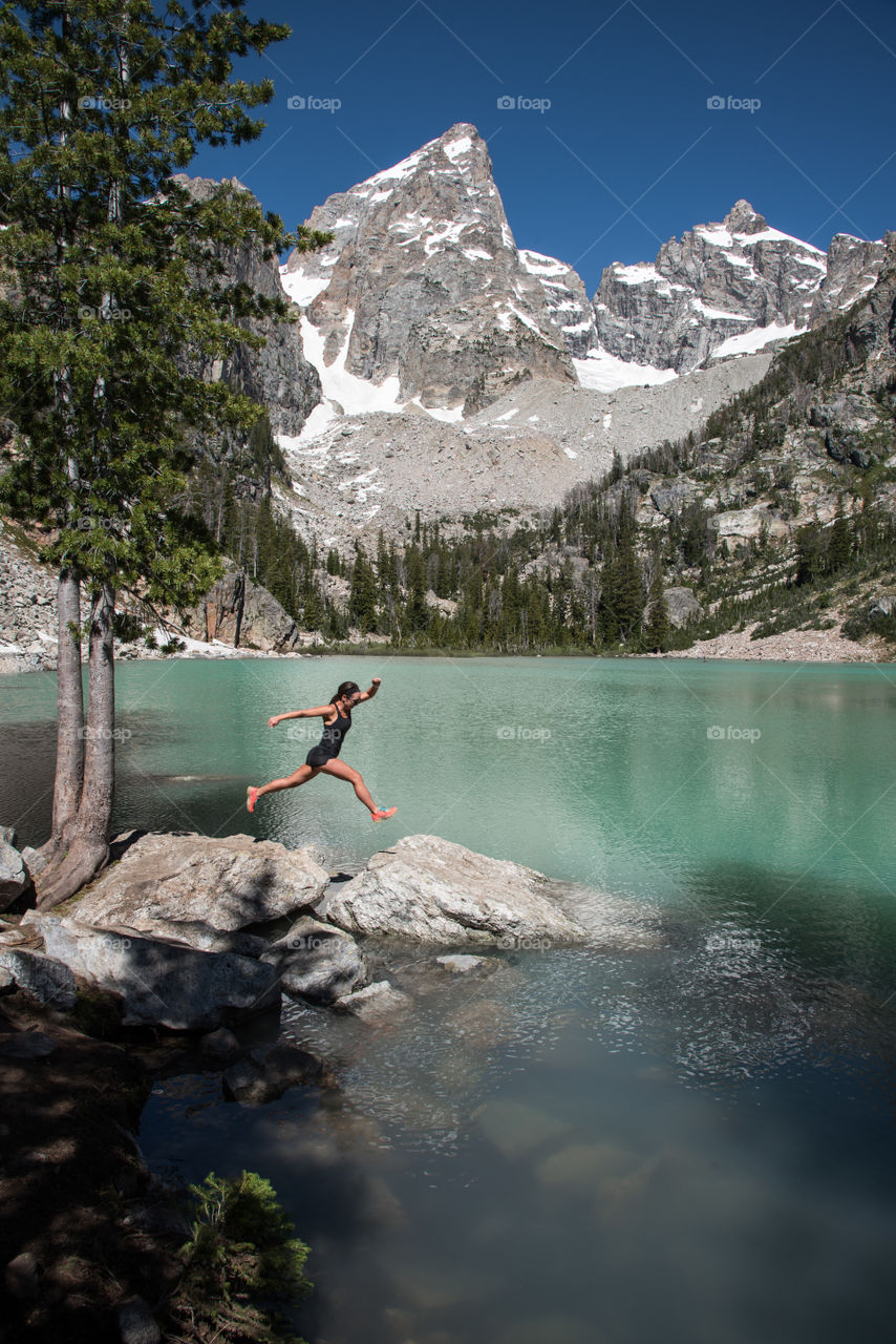 Rock hopping at a glacial fed alpine lake