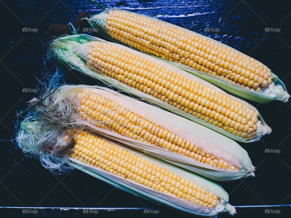 yellow corn on black, vegetables