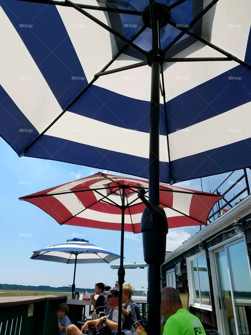 Umbrellas open at outdoor restaurant.