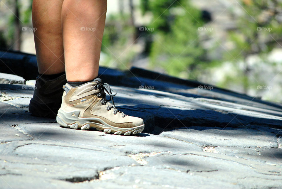 Mountain hike, focus on shoes, blurred view