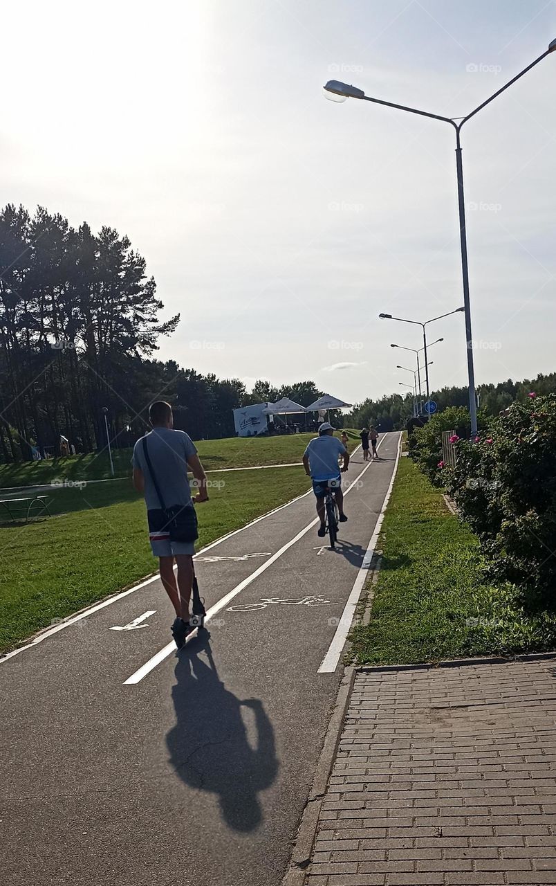 person on a electric scooter, summer time