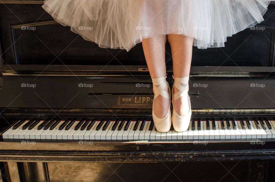 Ballerina Standing on A Piano