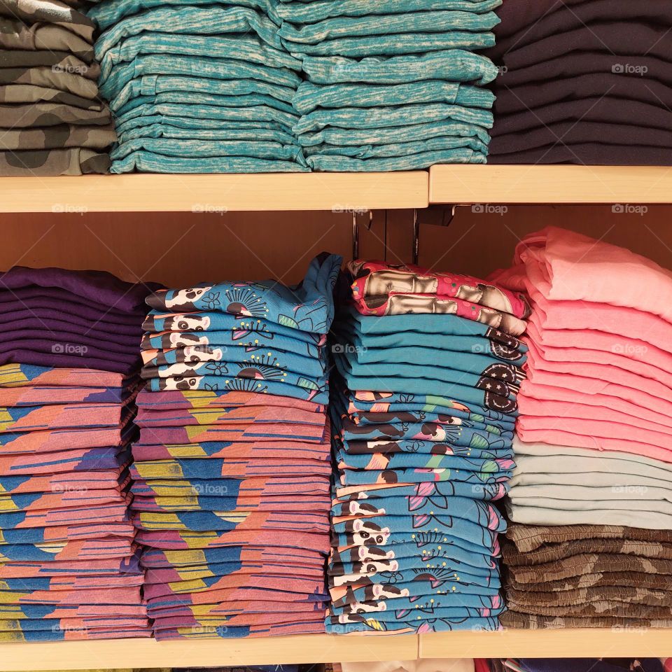 stacks of clothes folded neatly to attract shoppers