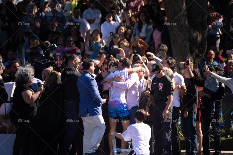 A beautiful moment at an Epiphany event celebration with the boy that got the cross hugging his family with the cheering crowd behind them