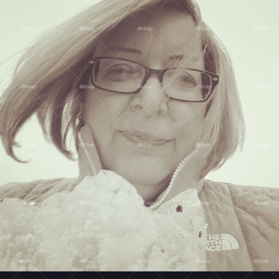 Wind was blowing and my hair was in my face I’m holding a big chunk of ice 