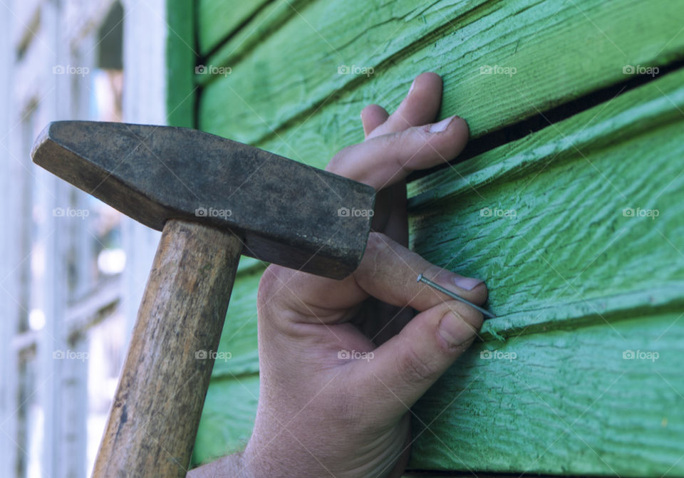 A man is hammering a nail