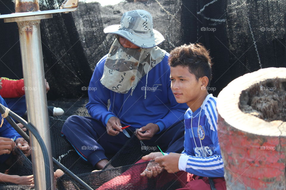 Mending fishing nets at Bangsaray Thailand - January 2016