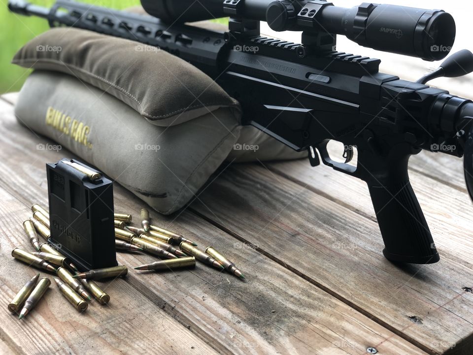Gun bullet ammunition and sand bag sniper ready to load and shoot 