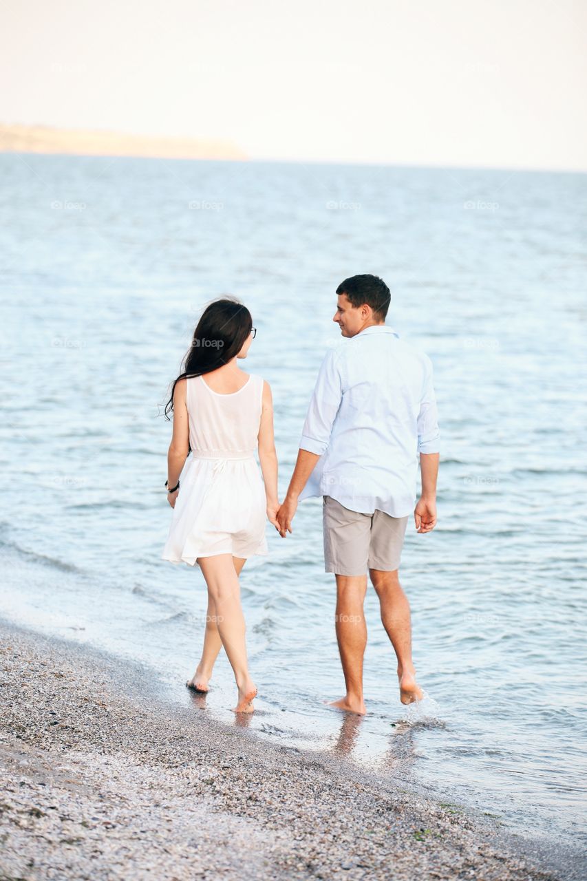 Love couple walking near sea. Paradise view