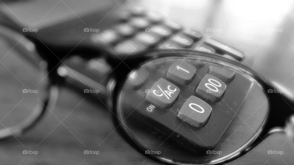 Myopia. Myopia (nearsighted vision) with eyeglasses and old calculator