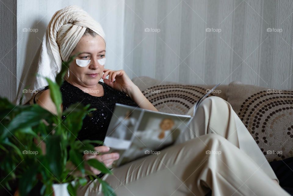 woman relaxing at home with magazine