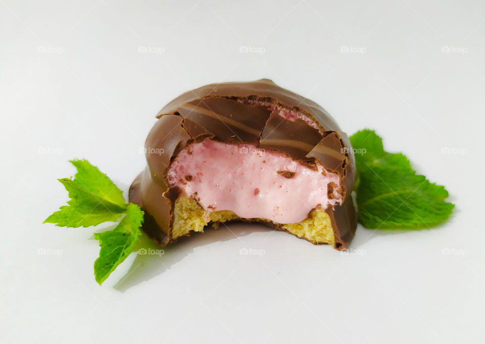 Dessert with creamy strawberry cream and mint leaves on a light background