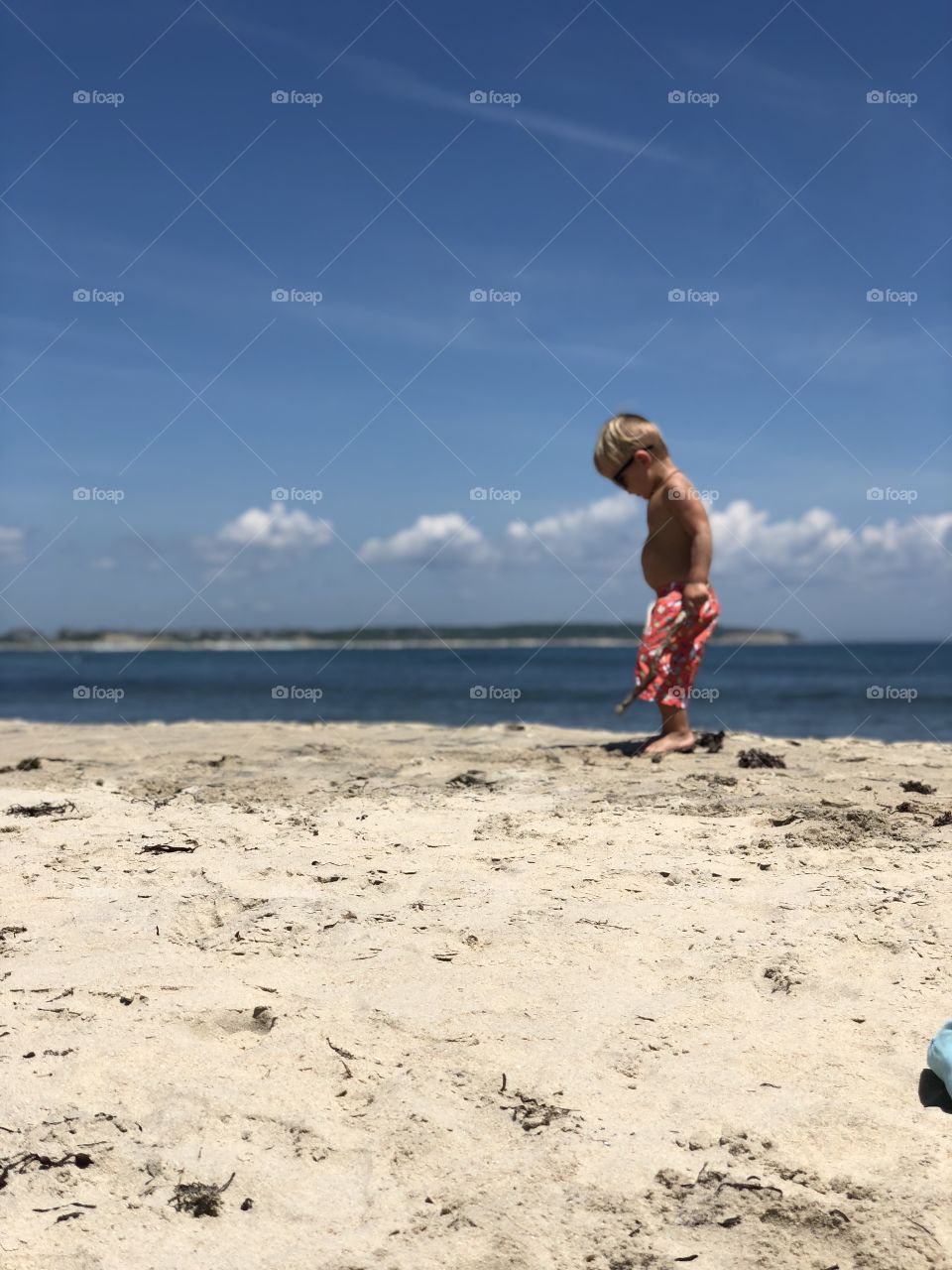 Little boy enjoying the beaches of Block island. 