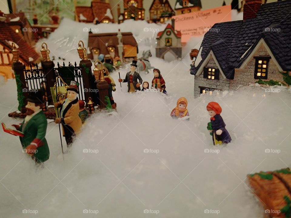 a Christmas village with characters dressed in the Victorian era. 