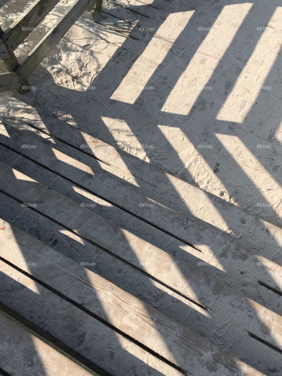 Railing shadow on boardwalk