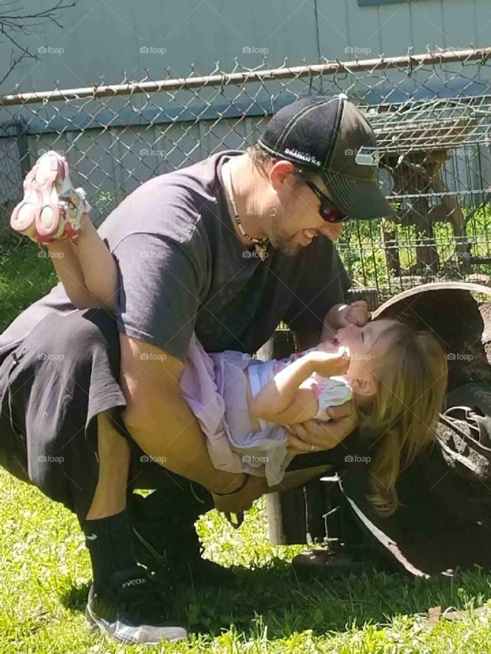a father and his daughter playing together in Vidor Texas United States of America 2018