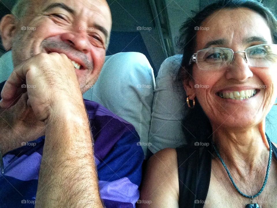 very happy couple, posing for a selfie inside a bus, heading to Rio de Janeiro -Brazil, vacation in the wonderful city.