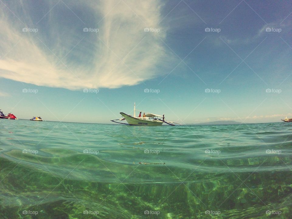 Boat in the middle. This photo was taken in Porto Galera, Philippines.