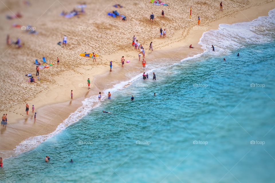 Busy Beach. A sandy beach full of holidaymakers from above.