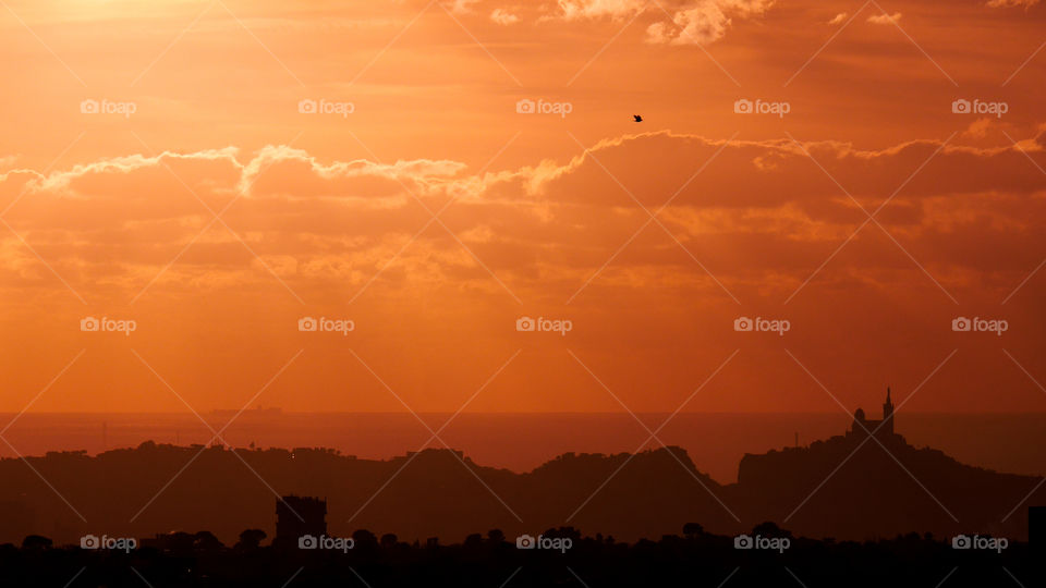 Scenic view of cloudy sky and mountain at sunset