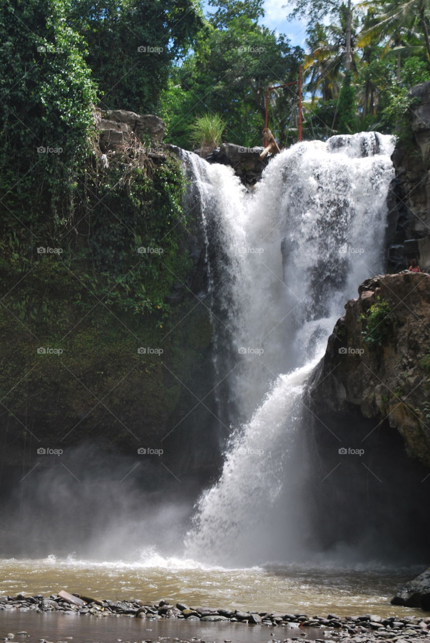 A crashing waterfall in Bali, Indonesia.