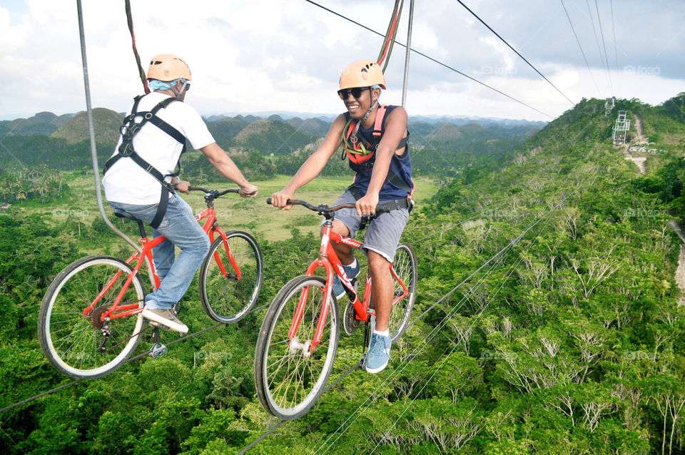 Men having fun riding  bike zip for summer vacation @ninaville9183