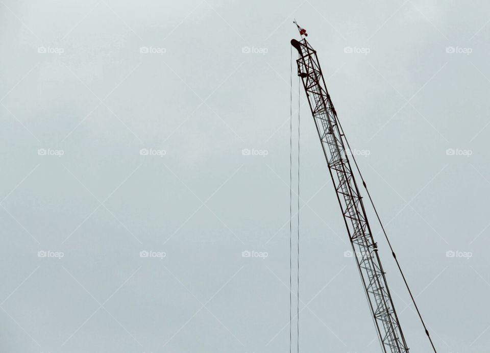 A minimalistic crane stands alone, in the urban development of Singapore today.