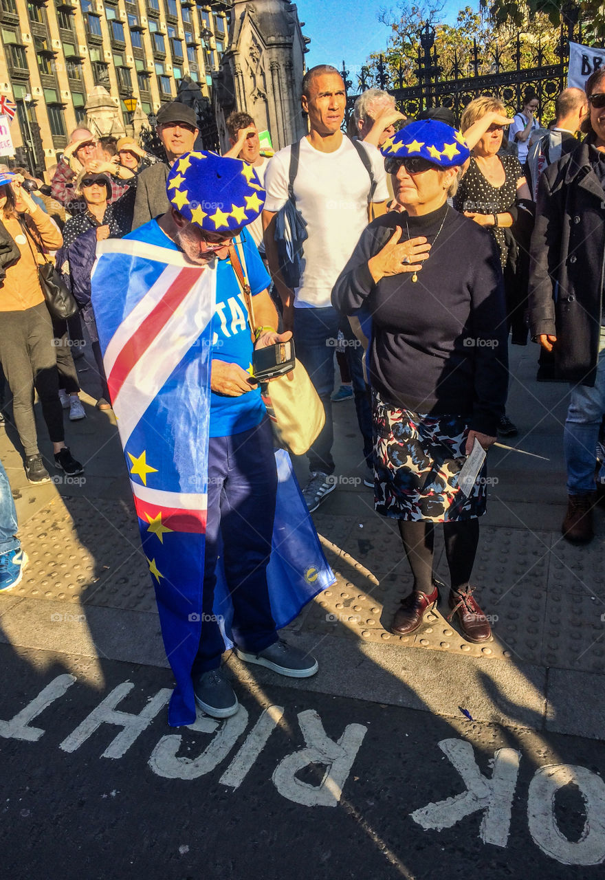 An older couple in EU styled blue berets, stand in the crowd at the People’s Vote March in London - 20th October 2018