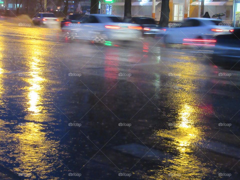 rainy evening in the city, road with cars, wet