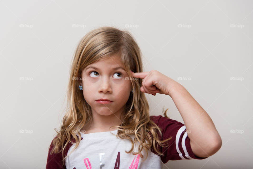Small girl standing against white background