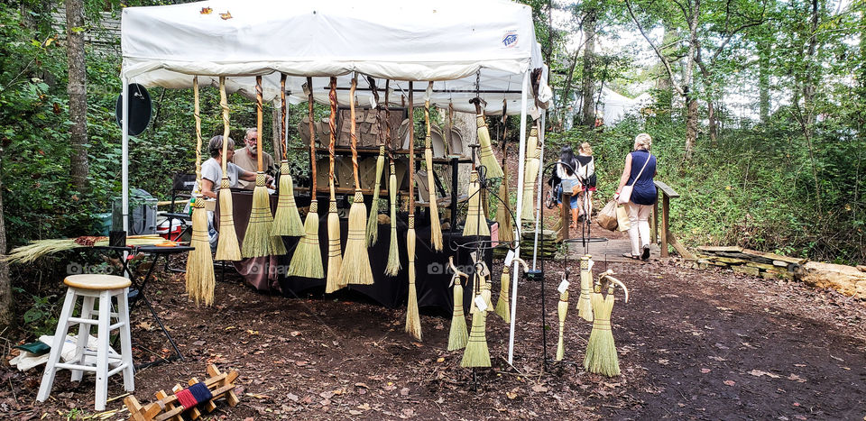 Brooms for sale at country fair.