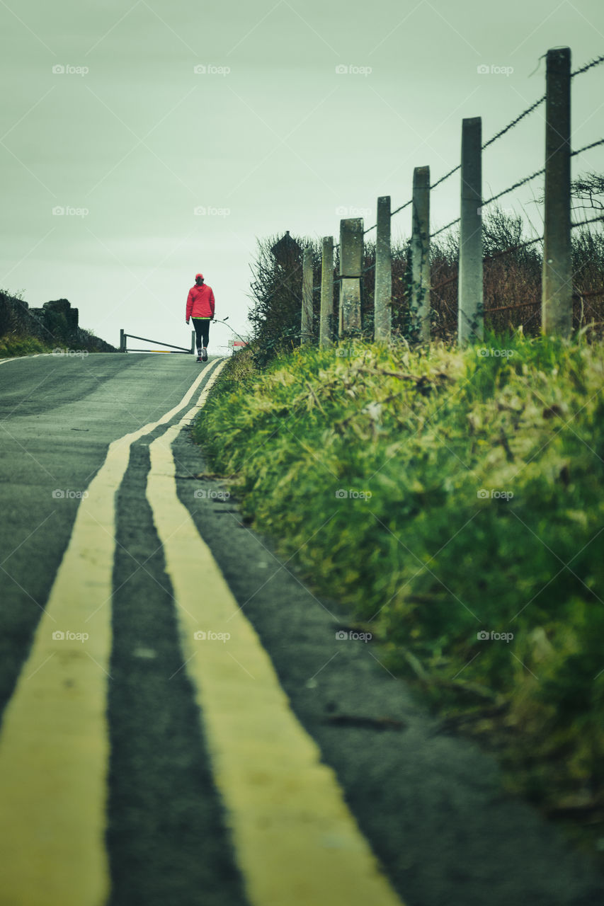 Woman in red coat jogging