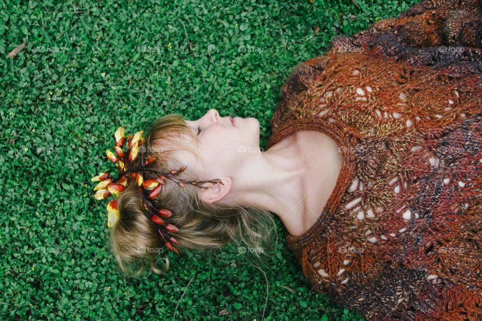 My friend sonja laying on the grass looking like a fairy with flowers in her hair.

