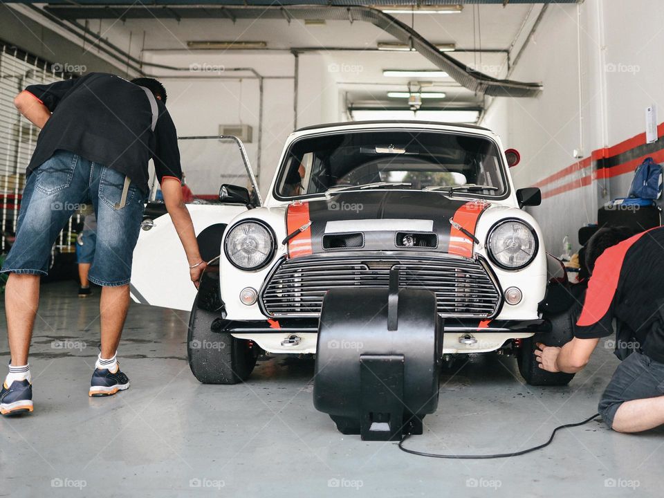 Two mechanic working on a mini in the paddock
