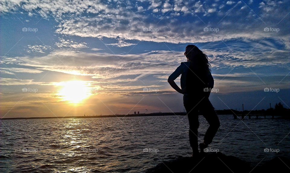 Silhouette of a girl at sunset