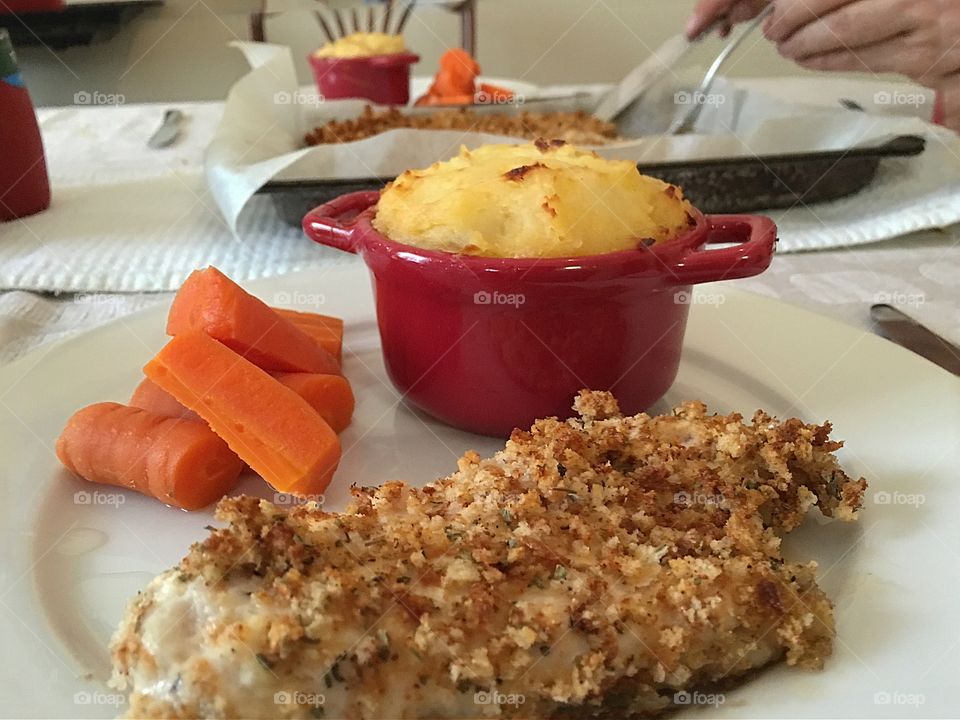 Gluten free breaded chicken tenders, baked potato and veg pudding, steamed carrots dinner food