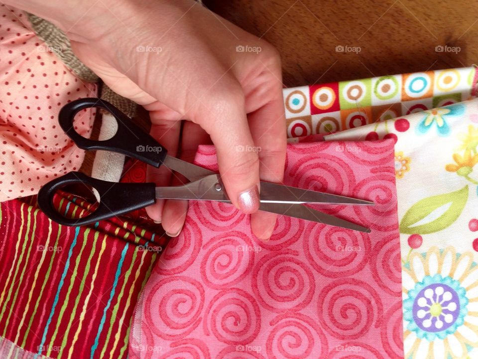 Women hand working with tissue and scissors  