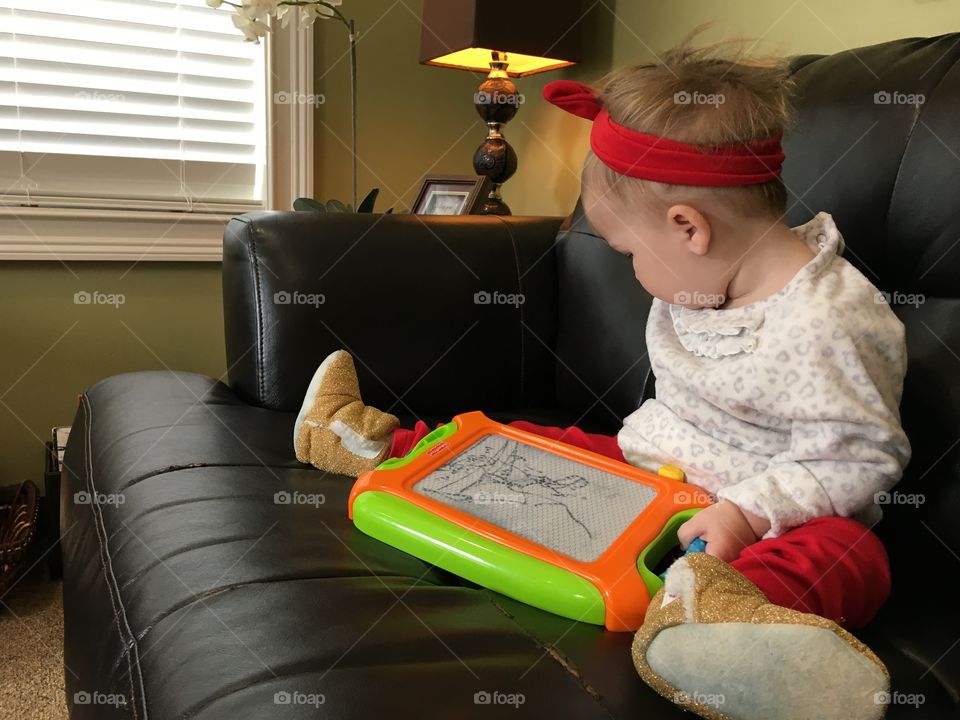 Toddler drawing on magnetic board