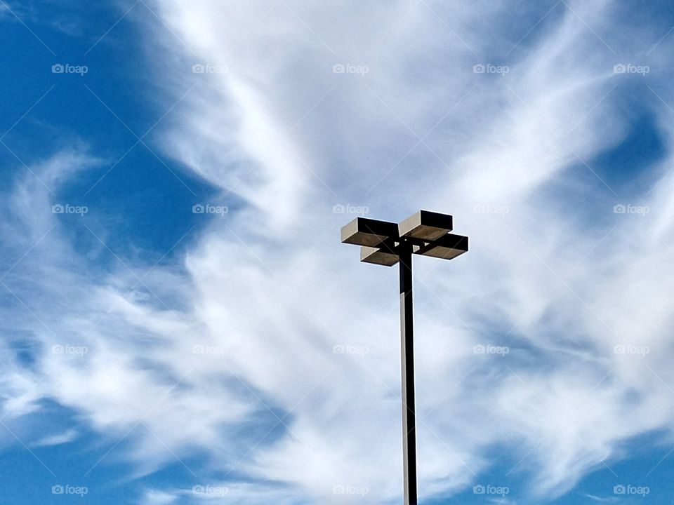 Clouds above light pole