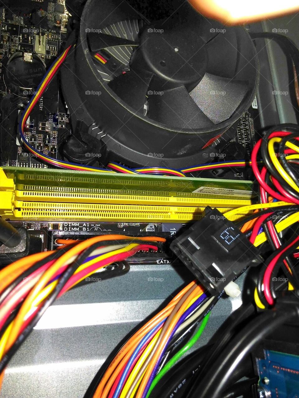 Some cables, cooling fans and parts of the mainboard in a computer