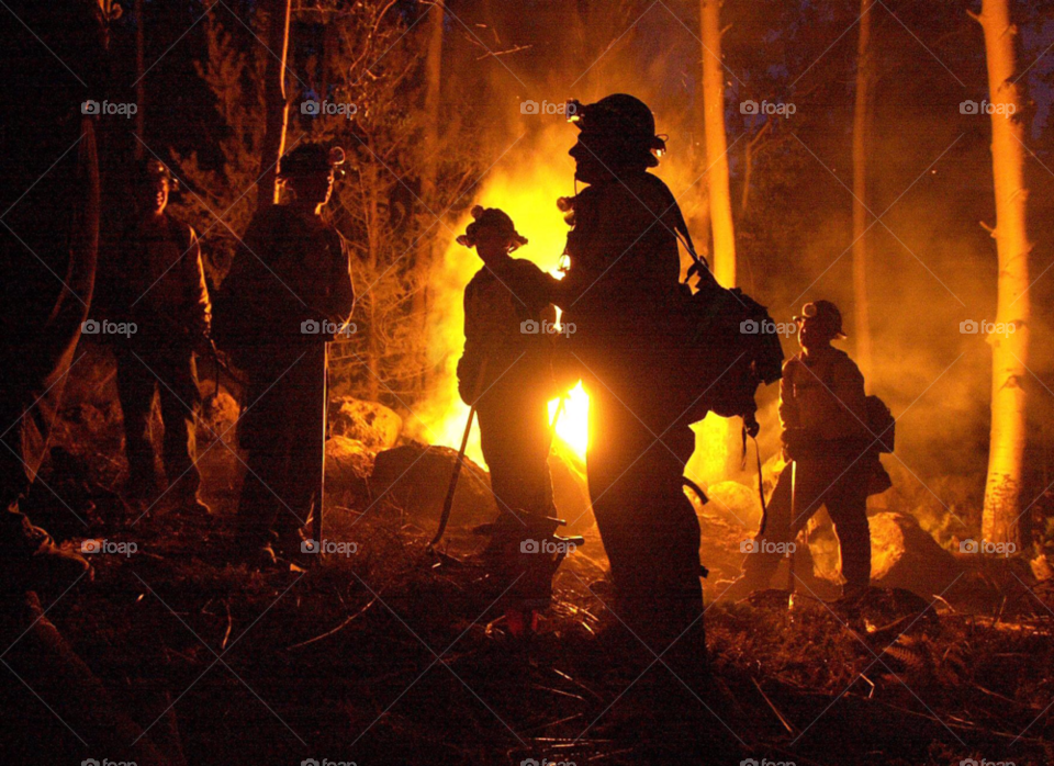 wildland firefighters work through the night battling a forest fire in the western united states. forest fire. western united states by arizphotog
