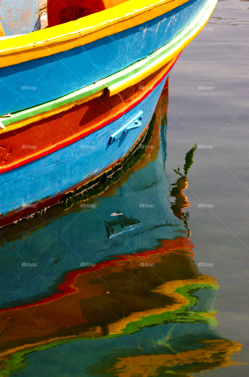 reflections of a colorful boat in the sea in Malta