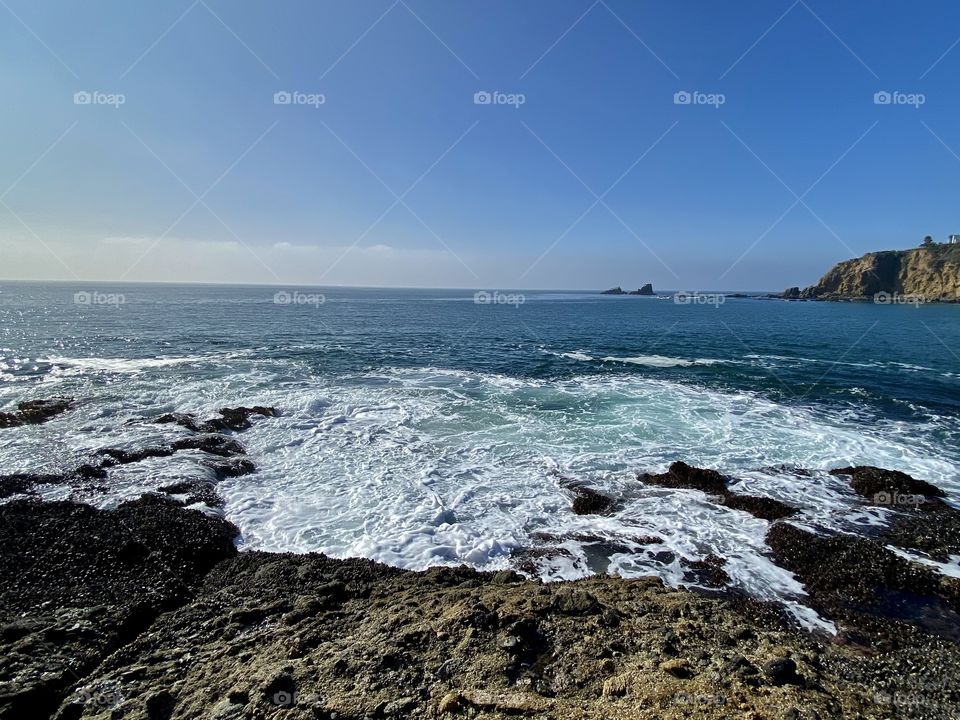 Wave hitting rocks at Crescent Bay Beach 