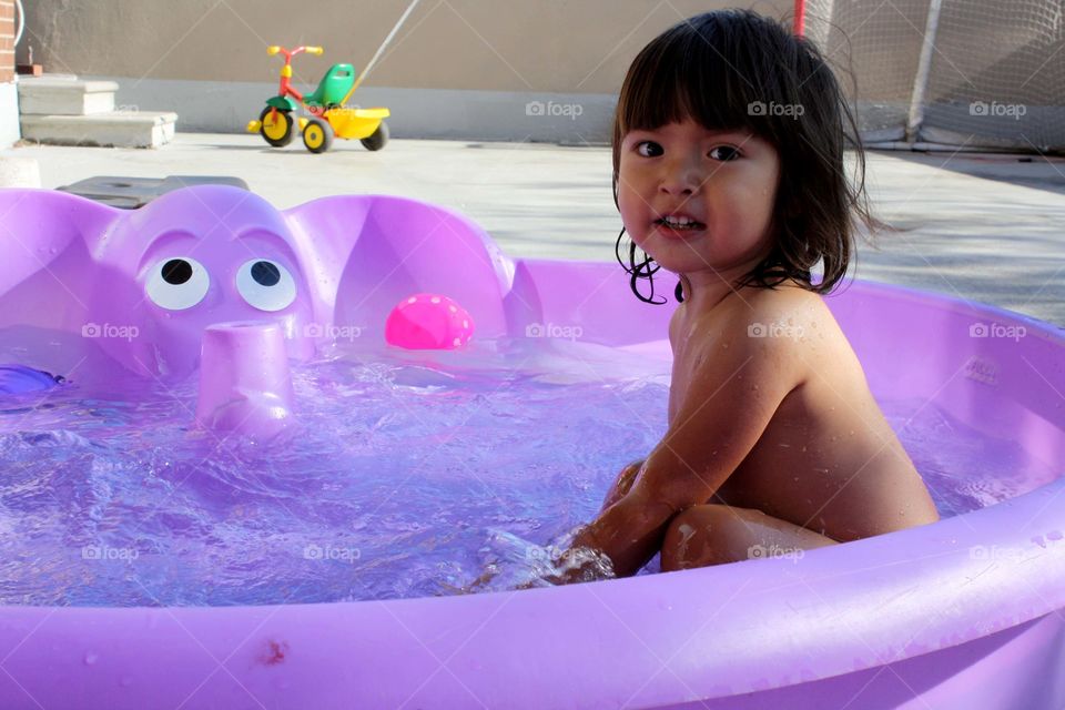 Cute little girl in a pool