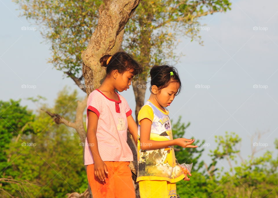 Friendship comparation of two indo-nesia female skin. Good times of two in spend the afternoon for walking on the beach. They'he share story anything, and just playing for the sand near the beach until the times shown for night and backhome together