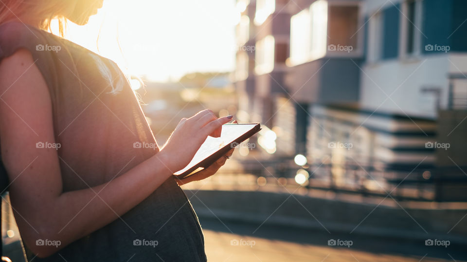 Woman using tablet on the street 