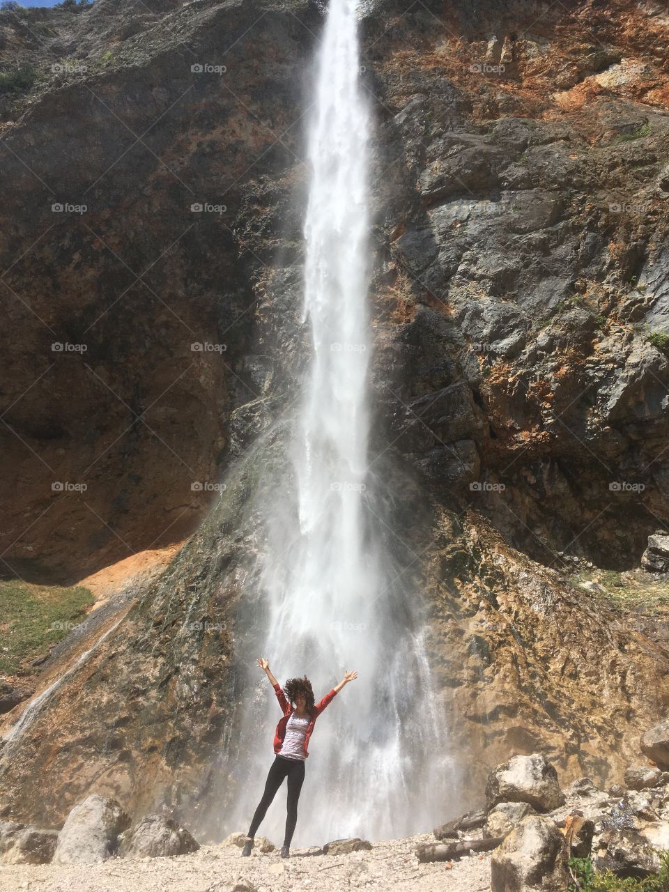 Girl under waterfall