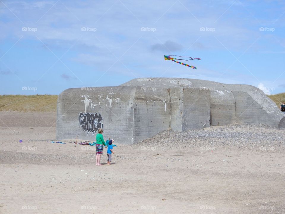 Flying a kite by a bunker